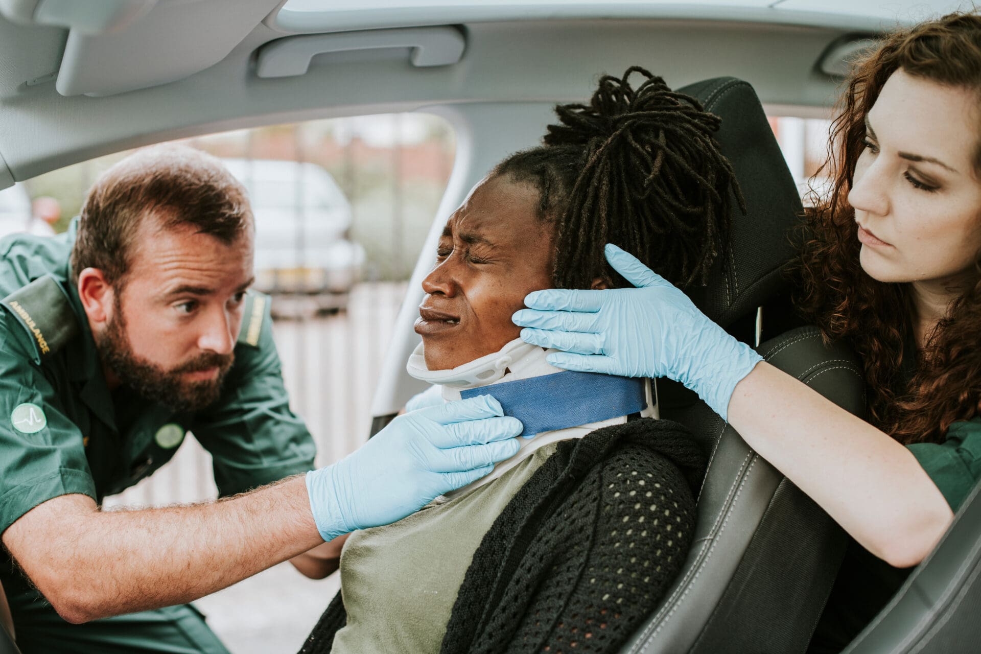 Paramedic placing a cervical collar to an injured woman from car Rideshare Accident
